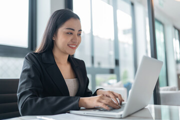 Beautiful Business Woman working by using laptop computer Hands typing on keyboard. Professional investor working new start up project. business planning in office. Technology business Concept