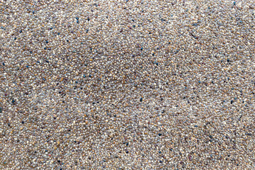 Close-up of small pebble stone concrete texture used in flooring or wall finishing.