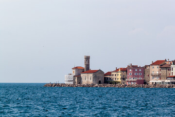 A vibrant panoramic view of Piran, Slovenia, showcasing the picturesque old town from the Adriatic...