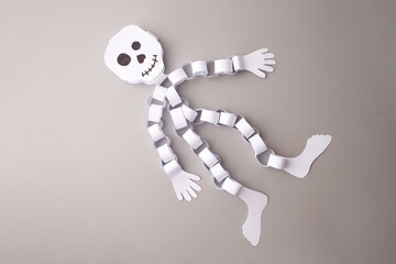 Flat lay DIY Halloween paper skeleton for social media content creators, handmade craft shops,...