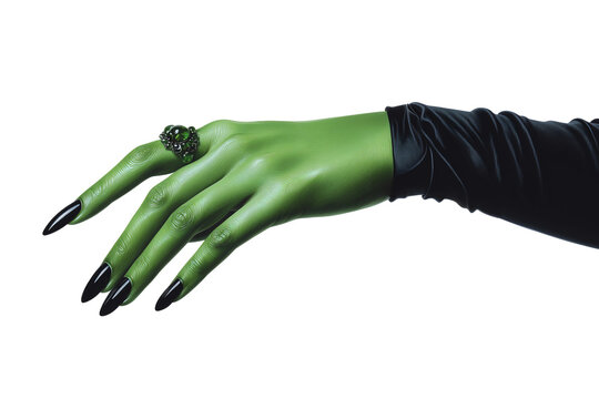 Green witch hand with long black fingernails and ornate ring extending from black sleeve against transparent background.
