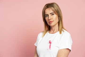 Woman wearing pink ribbon showing support for breast cancer awareness