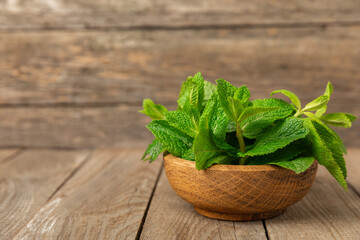 Mint. Fresh organic mint leaves on wooden background. Mint leaves. Peppermint. Close-up. Space for text. Copy space.