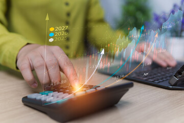 Financial analysis, stock market investment, gold trading trends, dividend budget estimation, annual trading income and profit, candlestick charts, woman calculating with calculator and laptop device.
