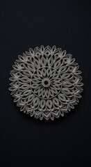 Intricate paper-cut mandala, circular design, grey tones, artistic craft, detailed artwork.