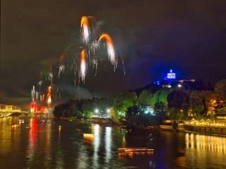 Fireworks over the Po River in Turin, Italy, during the San Giovanni celebration, with illuminated...