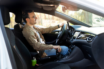 Man driving modern car on sunny day