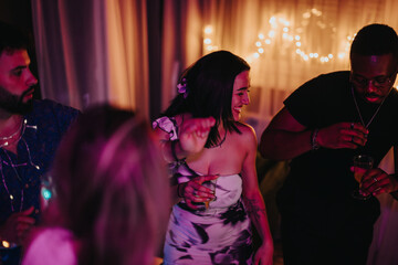 Friends celebrating together in a cozy atmosphere, featuring energetic dancing and cheerful...