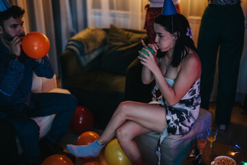 A cozy gathering at home among friends celebrating a joyful birthday with party activities.