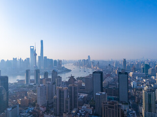 Fototapeta premium Aerial view of Shanghai skyline with winding river at sunrise.