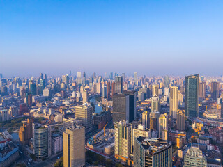 Aerial view of Shanghai skyline with winding river at sunrise.