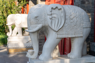 Two carved elephant statues bathed in sunlight