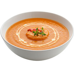 Creamy orange soup in a white bowl garnished with a lobster dumpling and cream swirl. Appetizing and delicious food photography