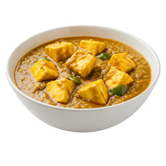 Close up view of a bowl of creamy yellow curry with light brown cubes of paneer cheese and flecks of green pepper. The bowl is white and sits on a
