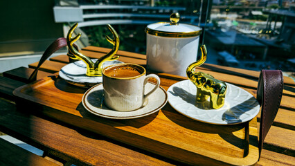 Turkish coffee served with golden decor on a wooden tray