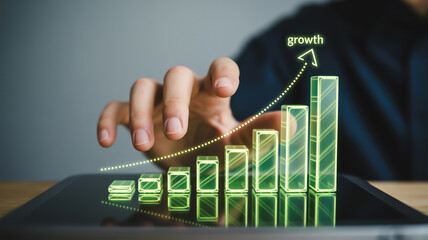 A close-up photograph of a hand interacting with a holographic green 3D bar graph visualization.