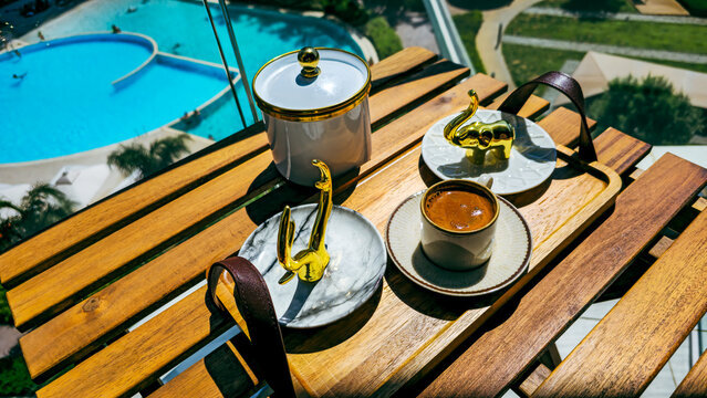 Turkish coffee served with golden decor on a wooden tray