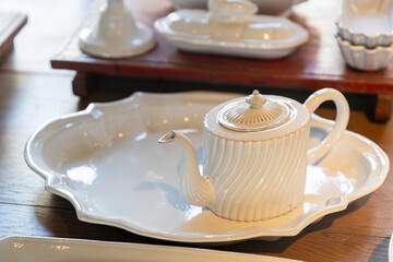 Elegant white ceramic teapot and serving tray. Flea market