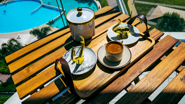 Turkish coffee served with golden decor on a wooden tray