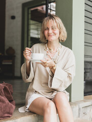 stylish girl, blonde holding cup of coffee, warming drink, good start of day, coffee aroma