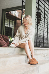 stylish girl, blonde holding cup of coffee, warming drink, good start of day, coffee aroma