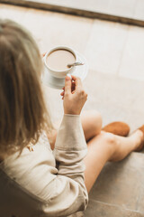 stylish girl, blonde holding cup of coffee, warming drink, good start of day, coffee aroma