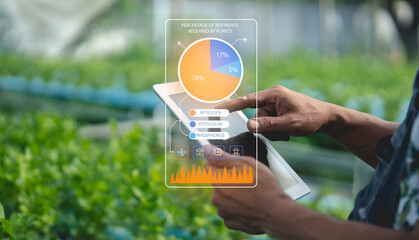 A person uses a tablet to analyze plant nutrient data, with a digital overlay showing percentages of nitrogen, potassium, and phosphorus for precision agriculture.