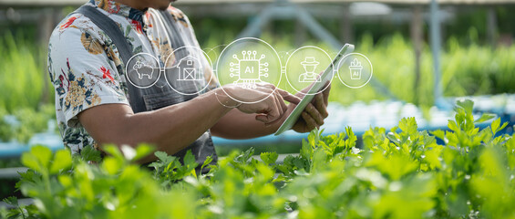 A person uses a tablet in a green agricultural setting, integrating technology and AI to monitor...
