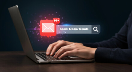 Modern Digital Trends: A person, fully engrossed, interacts with a sleek laptop to navigate the boundless world of social media trends.