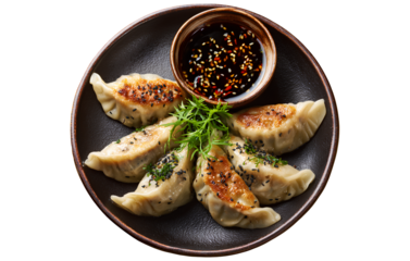 Distinctive gyoza dumplings with sauce on a plate, transparent background