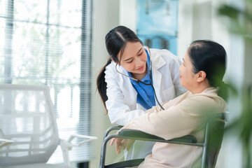 experienced female medical professional explains test results to a female patient during a clinic consultation. reviewing reports and discussing diagnosis and treatment options.compassionate care