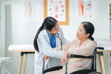 experienced female medical professional explains test results to a female patient during a clinic consultation. reviewing reports and discussing diagnosis and treatment options.compassionate care