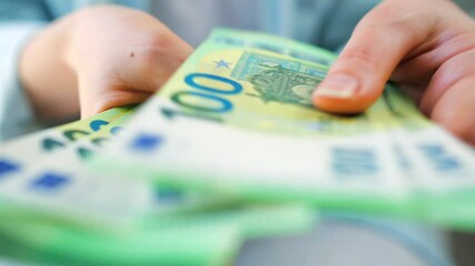 Woman counting euro bills, close-up - Powered by Adobe