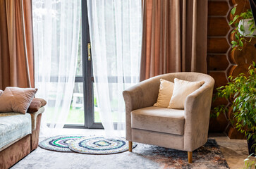 Living room interior with mock up poster frame, beige sofa, round wooden coffee table, rug, pouf,...