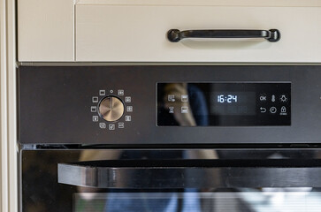 Modern kitchen has an oven and the control panel, oven control panel