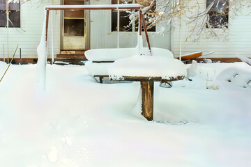 Backyard Swing and Picnic Table Covered in Deep Snow During a Rural Winter Storm

