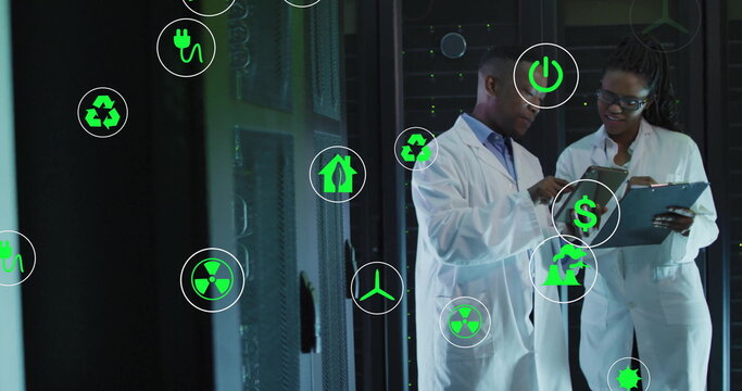 Holding clipboard, researchers in lab coats analyzing energy data at server racks with energy icons