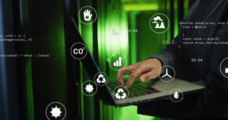Korean man in jacket monitoring server racks in data center, with laptop, eco icons and JavaScript