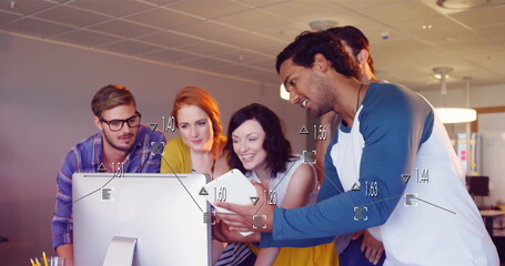 Collaborating five coworkers leaning around monitor at office, with smartphone and pen holder