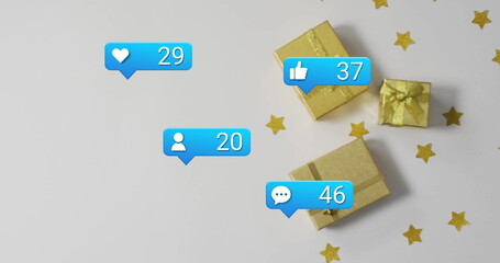 Showing gold gift boxes with confetti on white table, social media notification icons, copy space