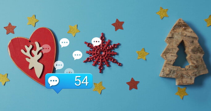Showing red snowflake shining on blue table with heart ornament, tree cutout, chat notification 54