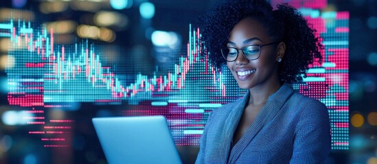 A smiling businesswoman analyzes a financial chart on a laptop. The background shows blurred city lights and a stock market display.