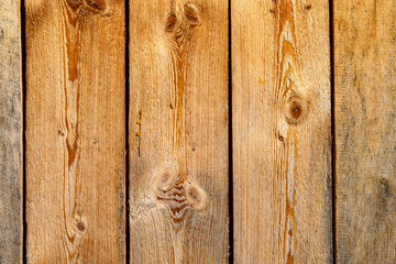 Wooden planks display a rustic charm with visible grain patterns and knots. The natural hues of brown and tan provide a warm and inviting appearance,for copy space.