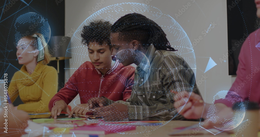 Poster collaborating team pointing at sticky notes and writing in meeting room with globe overlay