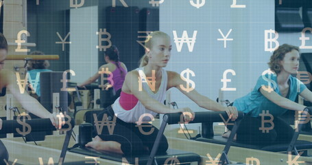 Practicing Pilates on reformers, blonde woman in activewear pulling handles in studio with mirror