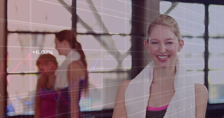 Standing female in sleeveless top draping towel around neck in gym with digital charts, copy space