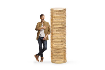 Full length portrait of a casual man in checkered shirt and jeans leaning on a pile of coins and...