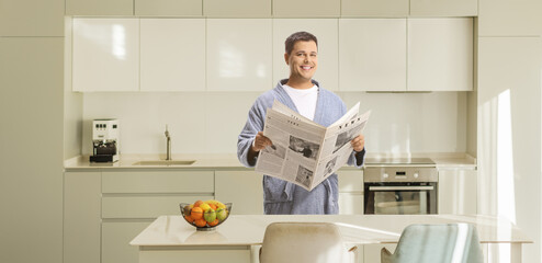 Man in a bathrobe standing in a kitchen
