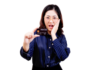 Asian young beautiful woman with glasses and a striped shirt holds up a credit card while expressing surprise or excitement.