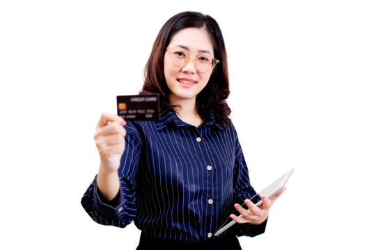 Asian young beautiful woman wearing glasses and a striped shirt is holding a credit card in one hand and a tablet in the other, smiling confidently.
